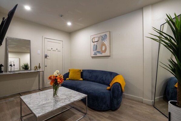 Stylish open-concept living area with chic accents and comfy seating.