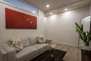 Living room with a red painting.