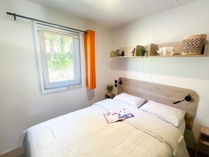A tranquil bedroom featuring stylish decor and playful accents, creating a perfect retreat for restful family nights.