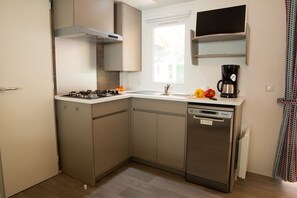 Fully equipped kitchenette featuring a dishwasher and all the essentials for a comfortable stay.