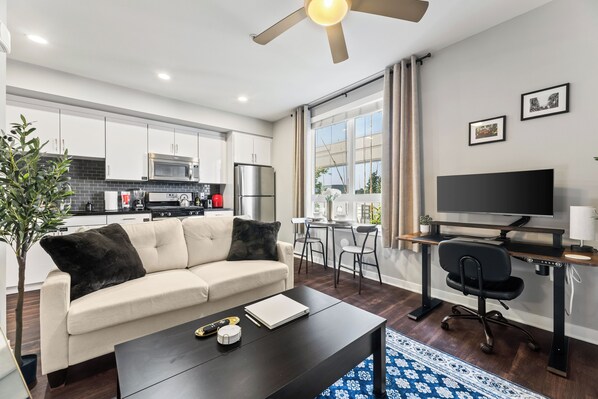 Standing desk, full kitchen, coffee table extends to couch table