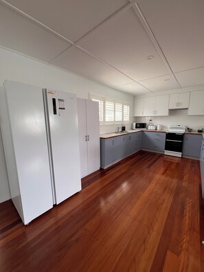 Full kitchen with fridge, freezer, microwave, toaster, kettle, crockery, etc.