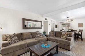 Step into our cozy living area, where sunlight dances on warm hues and every corner invites relaxation.
