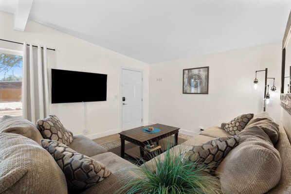 Relax in our living area, complete with a comfy sofa and a sleek TV—perfect for movie nights and casual gatherings!