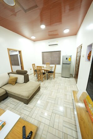 Living room that emphasizes the seating arrangement and the warm wooden ceiling.