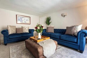 Living room with two sofas, occasional chair and TV (Toshiba 50" smart TV with Netflix, BBC iplayer, ITVx, My 5)