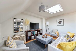 Spacious, light-filled sitting room with comfortable sofa bed if required