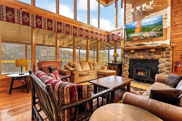 Bright living area with ample seating, TV, gas fireplace and stunning views