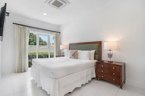 Bright and spacious queen size bed retreat with soft linens and plush pillows - Large windows let in natural light, creating a warm and inviting ambiance - Thoughtfully designed with elegant furniture, cozy lighting, and plenty of storage space