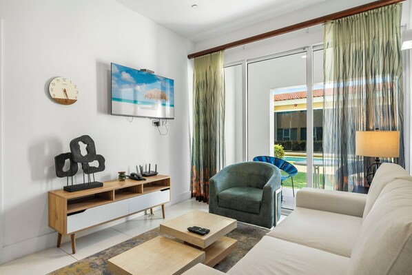 Cozy living area with smart TV and patio access