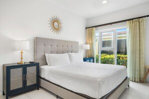Bedroom 1 features a king size bed and a pool view