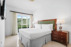 Inviting bedroom featuring a king size bed, warm lighting & serene ambiance - Sunshine streaming through the balcony doors, perfect for a refreshing start to your day - Enjoy a restful stay with soft linens, elegant furnishings & modern amenities