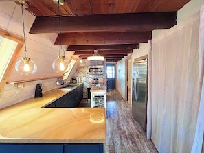 updated kitchen with new, stackable washer/dryer behind the curtain (1)