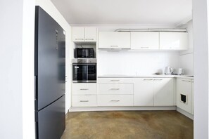 Recently renovated, this kitchen space is contemporary and chic. The long stone benchtop makes cooking easy, while an induction stove, large oven and appliances will get your cooking creations started. 