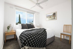 There is ample space for storing your belongings, timber side tables and a pretty sitting chair for relaxing in privacy. 