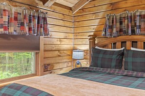 Primary bedroom sits at the back of the cabin, overlooking the creek. Total privacy abounds here.