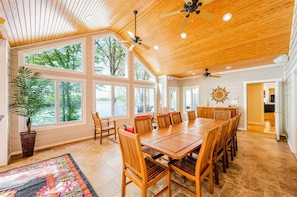 Our fun SUN room!! Just off the kitchen and Ideal for large dinner parties and lots of FUN! Ample seating, bar area, surround sound, gorgeous lake views and a cool, boho vibe! We LOVE hosting