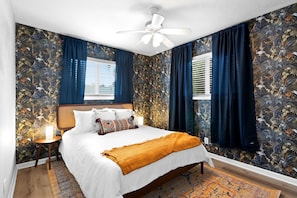 Bedroom with plush beddings and windows with room darkening shades