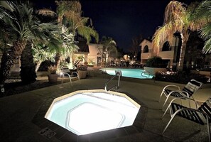 Night view of hot tub and pool. 