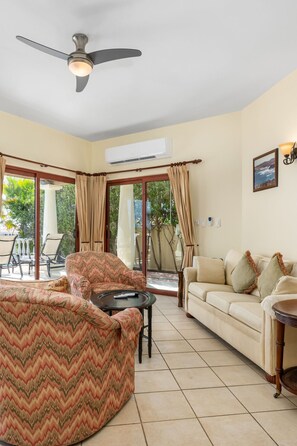 Step into comfort and style in this inviting living space, seamlessly blending indoor relaxation with outdoor beauty.
