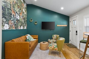 Comfortable living room with lots of natural light! Smart TV with all the apps you could want. The couch turns into a futon sofa. Lush, vibrant decor throughout the entire condo!