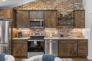 Fully equipped kitchen with all your cooking essentials, drip coffee maker + coffee. Dining table with seating for 2. This room opens up into the living room. Rustic and bold western decor throughout the entire condo!