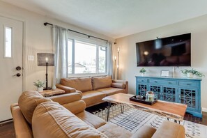 Spacious Living Room with Comfy Seating, Large Smart TV and Plenty Of Natural Light