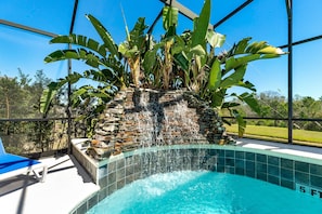 This tropical-inspired corner of the pool offers a soothing spa and waterfall backdrop, bringing a resort-style vibe right to your private retreat.