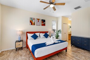 This spacious master bedroom features serene pool views and king-sized bedding, creating a peaceful retreat designed for comfort and relaxation.