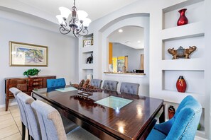 Formal dining room with seating for 8, ideal for family meals and entertaining guests.