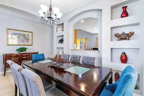 Formal dining room with seating for 8, ideal for family meals and entertaining guests.