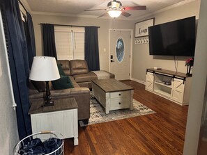 MAIN LEVEL, LIVING ROOM:  Large  Screen Smart TV with  remote Gaming Table below and Games.