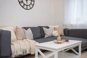 Relax in this open, cozy space with a comfy sectional, stylish decor, and a chic dining area.