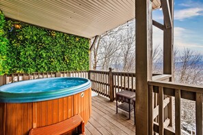 Escape to your private spa oasis, where a vibrant green wall meets snow-kissed scenery and peaceful mountain vibes.