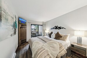 The tastefully decorated bedroom has a 32&quot; HDTV, access to the balcony and plenty of clothing storage