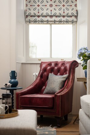 Coachman's Cottage - an armchair beside the log burner