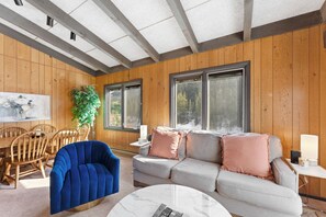 Living area with a gas fireplace, flat-screen TV, and balcony access.