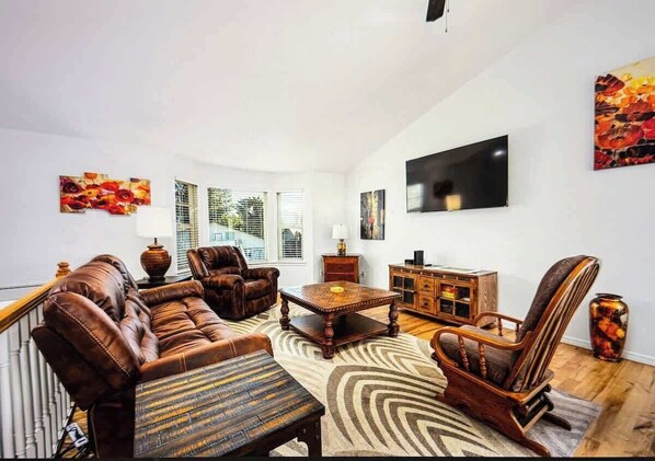 Upstairs Living Room has a large TV and comfortable Leather Couches.
