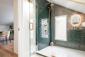 Luxurious bathroom in Unit 3 featuring a walk-in shower and modern subway tile design. A perfect place to refresh after attending the Stratford Festival, exploring the Avon River, or dining at downtown Stratford Ontario’s top restaurants. This stylish bat
