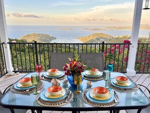 Outdoor dining on the pool deck with expansive views of Great Cruz Bay