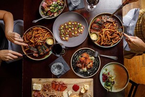The Ravenous Pig is known for its house-made charcuterie, which guests can see hanging in the fridge while walking to their table