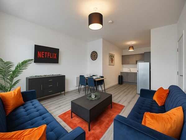 Comfy and stylish living area with Smart TV and open plan kitchen and dining area