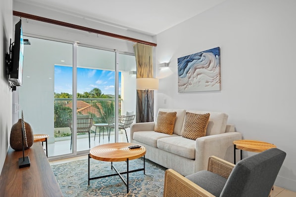 Relax in the bright and inviting living space with a view of the patio