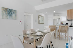 Gather around this glass dining table for delicious meals & great conversations - Enjoy a bright, open space that flows effortlessly into the cozy living area - Whether it’s breakfast or a celebratory toast, this spot is made for connection
