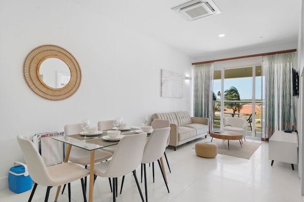 Kick back & relax in this inviting living space filled with natural light - Step onto your private balcony & enjoy a morning coffee with a refreshing view - Perfect spot to unwind, whether you're streaming your favorite show or diving into a book