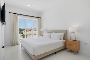 Sleep soundly in a spacious bedroom with a plush king-size bed and soft linens - Bright and airy space with large windows for natural light and refreshing views - Designed for ultimate comfort with elegant decor, soft lighting, and extra storage