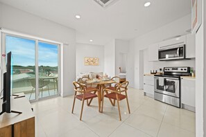 Fully equipped kitchen with modern appliances, perfect for home cooked meals - Enjoy your morning coffee at the cozy dining table or prepare a feast with ease - Bright, spacious, and functional, your ideal home away from home kitchen setup