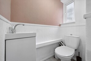 A compact and convenient half bathroom, offering everything you need in a stylish, functional space.