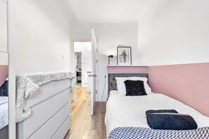 This bedroom is filled with natural light, creating a bright, airy atmosphere. The large window provides a lovely view and a refreshing vibe.