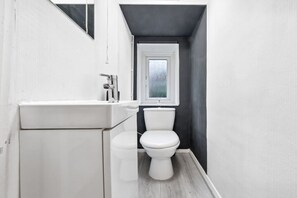 A well-appointed half bathroom with contemporary finishes. It’s ideal for quick use and adds extra convenience to your stay.